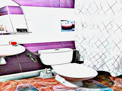 a bathroom with a toilet and a sink at Luxury 3-bedroom apartments 5-min to the Airport in Fès