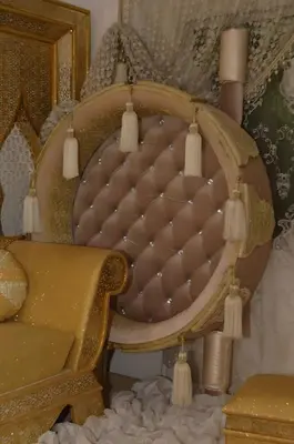 a chair in a living room with at Luxury 3-bedroom apartments 5-min to the Airport in Fès