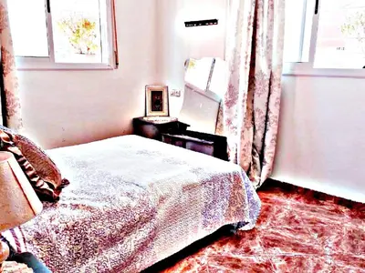a bedroom with a bed and a mirror and a window at Luxury 3-bedroom apartments 5-min to the Airport in Fès