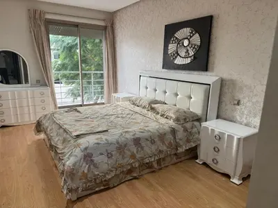a bedroom with a bed and a clock on the wall at Luxury appartement prestigia avec wifi fibre optique in Fès