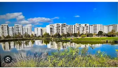 a view of a large apartment complex next to a lake at Luxury appartement prestigia avec wifi fibre optique in Fès