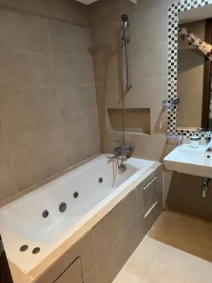 a bathroom with a bath tub and a sink at Luxury appartement prestigia avec wifi fibre optique in Fès