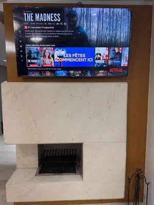 a fireplace with a tv on top of it at Luxury appartement prestigia avec wifi fibre optique in Fès