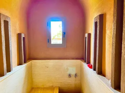 a room with a bath tub with a window at Villa avec piscine et jardin in Marrakech