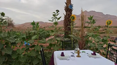 a table and chairs with a table and a view at Lodge Hara Oasis in Agdz