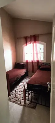 a room with two beds and a window at Quartier habri imouzzer kandar in Imouzzer Kandar