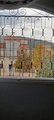 a window with a view of a building at Quartier habri imouzzer kandar in Imouzzer Kandar