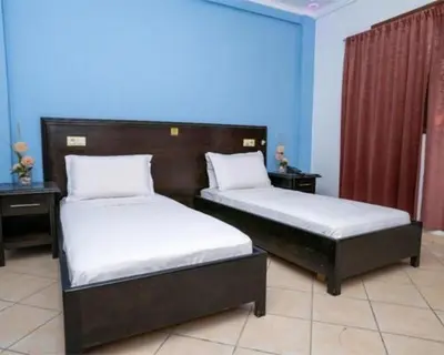 two beds in a room with at Hotel OUM EL FADL in Fkih Ben Salah