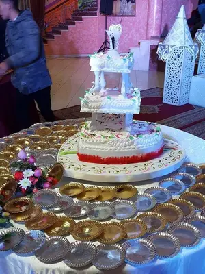 a wedding cake sitting on top of a table at Hotel OUM EL FADL in Fkih Ben Salah