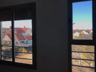 two windows in a room with a view of houses at AM Atlas Home in Ifrane