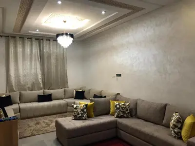 a living room with a large couch and a chandelier at AM Atlas Home in Ifrane