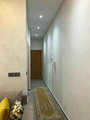 a hallway with a door and a rug on the floor at AM Atlas Home in Ifrane