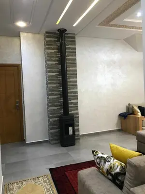 a living room with a black stove in a room at AM Atlas Home in Ifrane