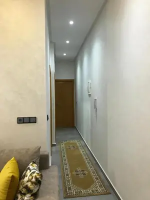 a hallway with a couch and a rug on the floor at AM Atlas Home in Ifrane