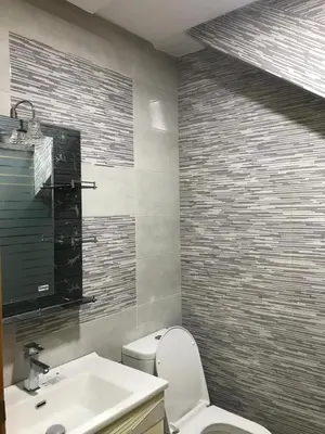 a bathroom with a white toilet and a sink at AM Atlas Home in Ifrane