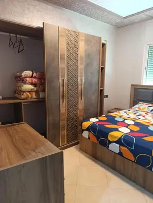 a bedroom with a bed and a large cabinet at Mifatima in Mrhila