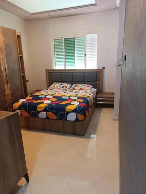 a bedroom with a bed with a colorful comforter at Mifatima in Mrhila