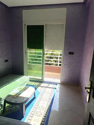 a bedroom with a bed and a window with a door at Mifatima in Mrhila