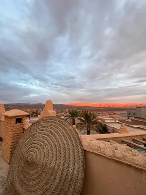 a large coil of rope sitting on top of a building at Kasbah Ennakb in Nkob