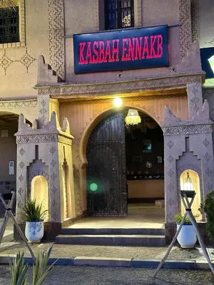 a entrance to a building with a black gate at Kasbah Ennakb in Nkob