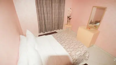 a bedroom with a white bed and a mirror at Darkoum, your apartment in fes city in Fès
