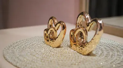 a pair of gold earrings sitting on top of a plate at Darkoum, your apartment in fes city in Fès