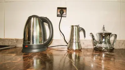 two tea pots and a tea kettle on a counter at Darkoum, your apartment in fes city in Fès