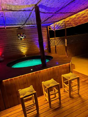 a swimming pool with two stools and a spa with at Paradise luxe in Fès