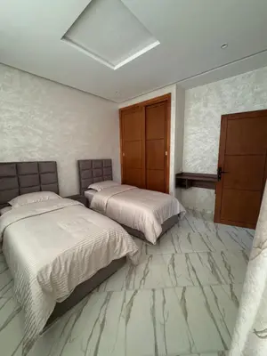two beds in a bedroom with marble floors at Paradise luxe in Fès