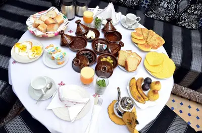 a table topped with breakfast foods and orange juice at Riad Dar Tahri & SPA in Fès