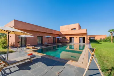 a swimming pool in front of a house at Villa de Luxe Ouidane 5 Chambres in Marrakech