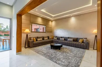 a living room with a couch and a table at Villa de Luxe Ouidane 5 Chambres in Marrakech