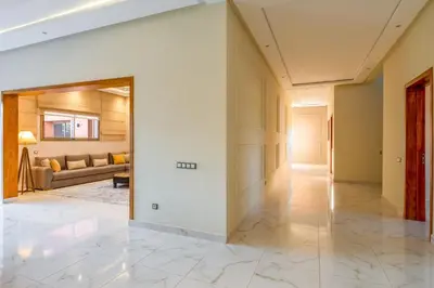a hallway with a living room with a couch at Villa de Luxe Ouidane 5 Chambres in Marrakech