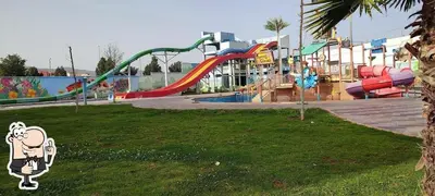 a park with a playground with a slide at Appartement Cosy avec piscine à Khenifra in Khenifra