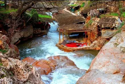 a river with a boat in the middle of it at Appartement Cosy avec piscine à Khenifra in Khenifra