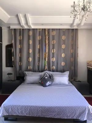 a bedroom with a large bed with a purple bedspread at Jamarou in Marrakech