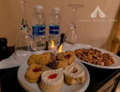 a plate of pastries and cookies on a table at Sahara Delight Camp in Merzouga