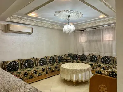 a living room with a couch and a chandelier at Dar Fes Medina - Guest Rooms in Fès