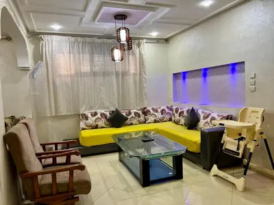 a living room with a yellow couch and a window at Dar Fes Medina - Guest Rooms in Fès