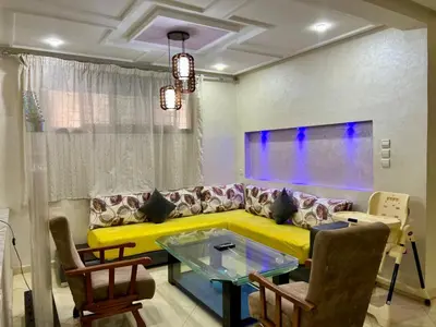a living room with a yellow couch and a table at Dar Fes Medina - Guest Rooms in Fès