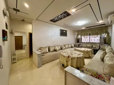 a living room with a couch and a table at Dar Fes Medina - Guest Rooms in Fès
