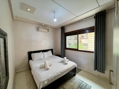 a bedroom with a bed with two towels on it at Dar Fes Medina - Guest Rooms in Fès