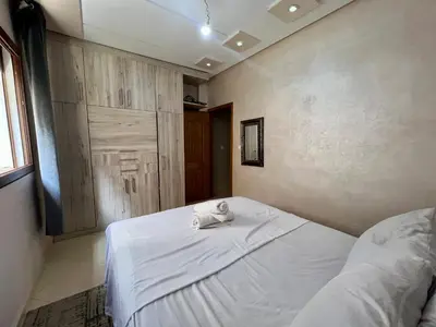 a bedroom with a bed with a towel on it at Dar Fes Medina - Guest Rooms in Fès