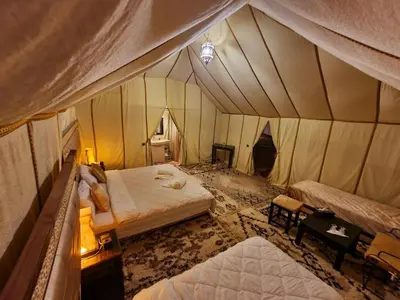 an aerial view of a bedroom with a tent at Adrar desert camp in Merzouga