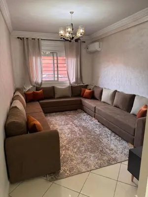 a living room with a couch and a rug at appartement a jawharat atlass 2 in Beni Mellal