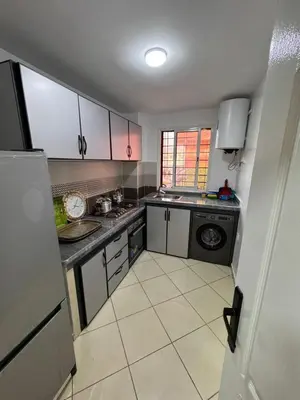 a small kitchen with a sink and a dishwasher at appartement a jawharat atlass 2 in Beni Mellal