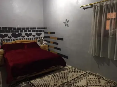 a bedroom with a bed and a wall with hearts on it at Ounilla valley in Tizgui nʼBarda