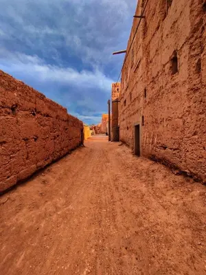 an empty dirt road in the middle of a desert at Ounilla valley in Tizgui nʼBarda