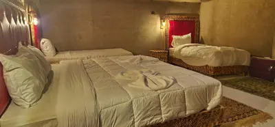 a hotel room with two beds and a mirror at Mountain luxury camps in Merzouga