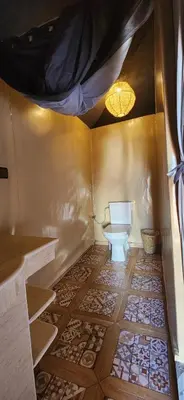 a bathroom with a toilet in a room at Mountain luxury camps in Merzouga